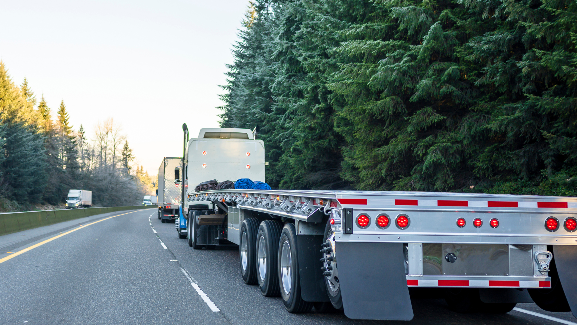 Flatbed truck driving through the forest